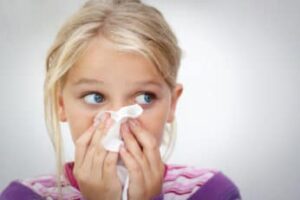 a sneezing young girl