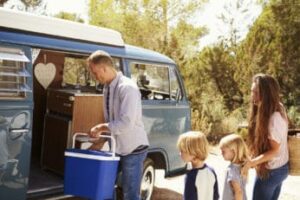 a-family-using-a-cool-box-for-camping