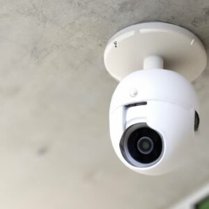 a white security camera on the ceiling